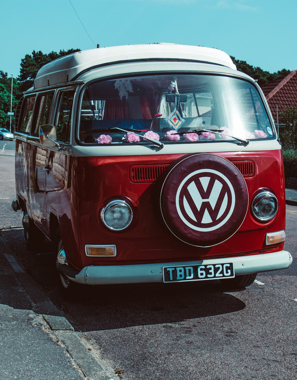 red Volkswagen T2 van parked near house