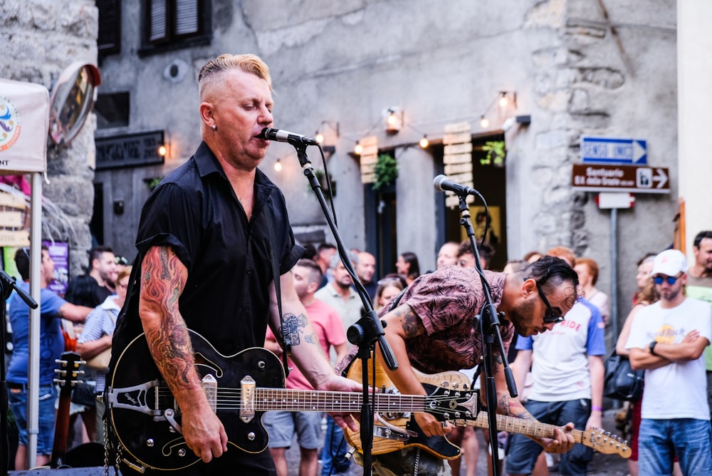 man playing guitar while singing