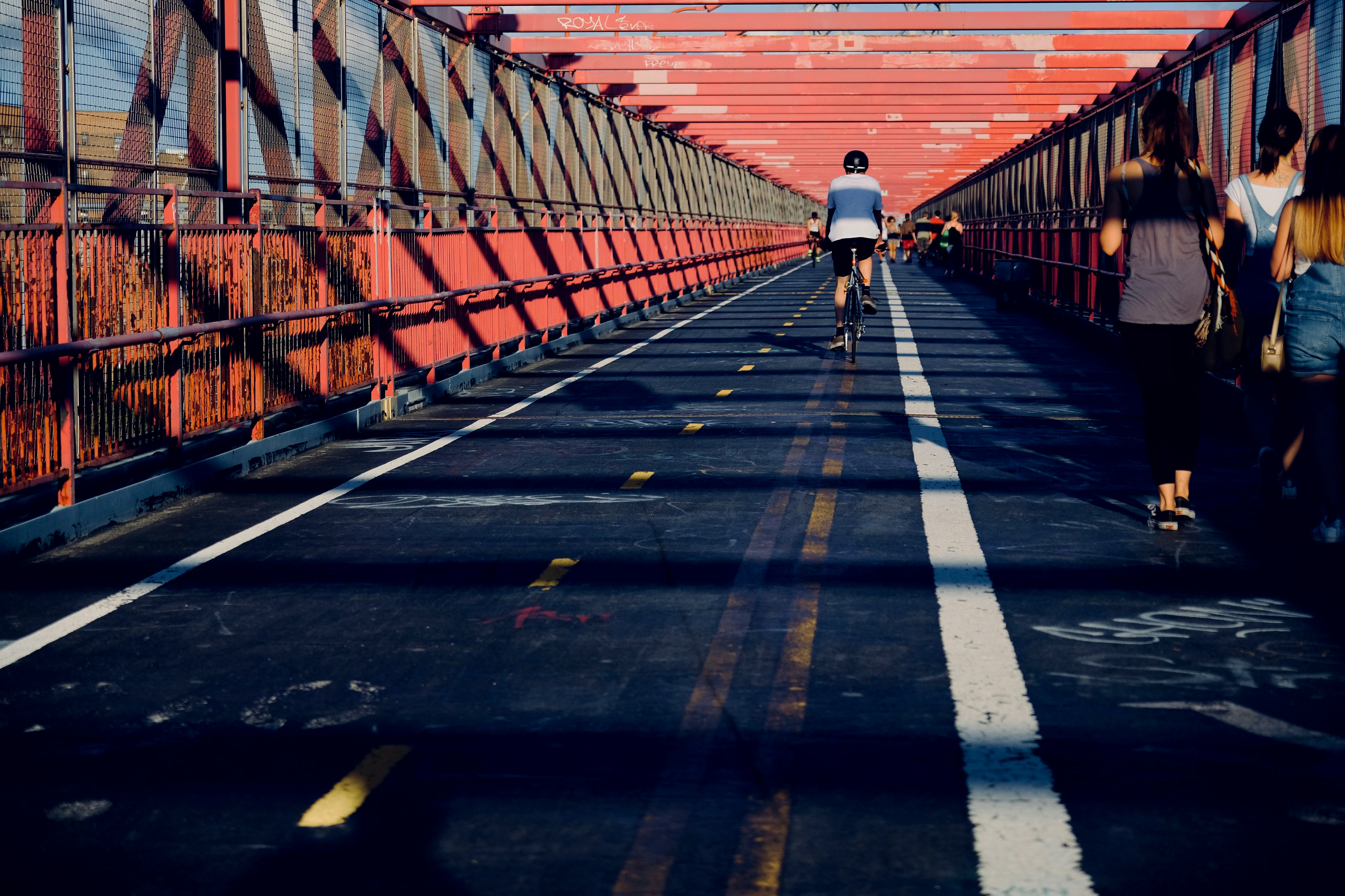 man riding bicycle in the middle of the street