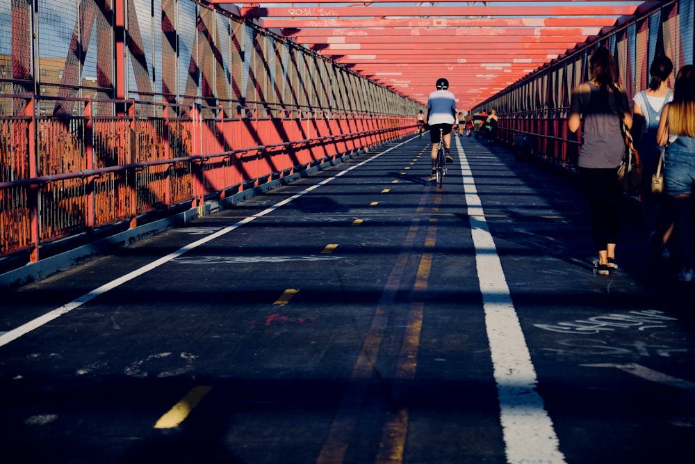 man riding bicycle in the middle of the street