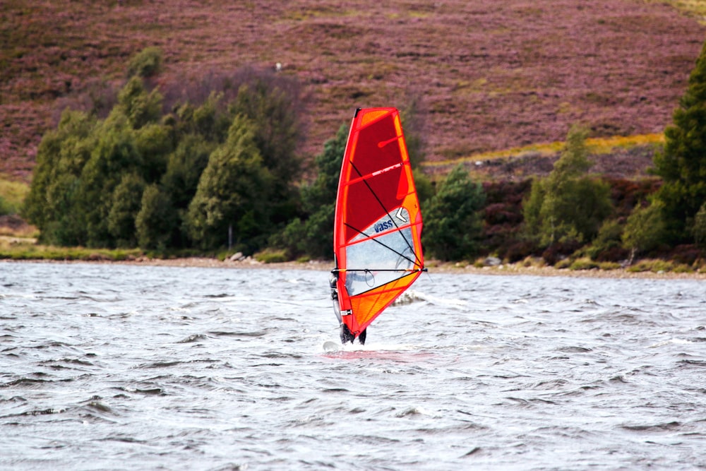 person on surfboard with sail