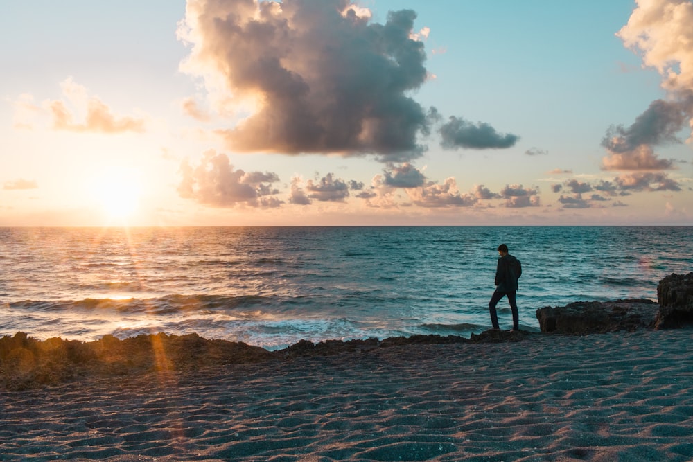 silhouette of man on seashore