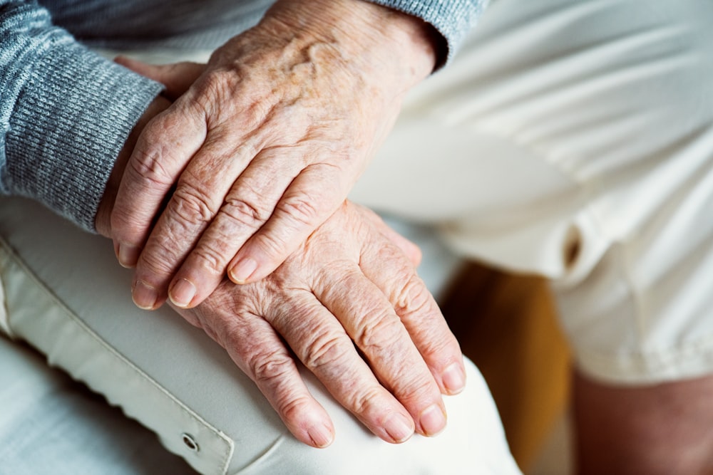 person's hands on lap