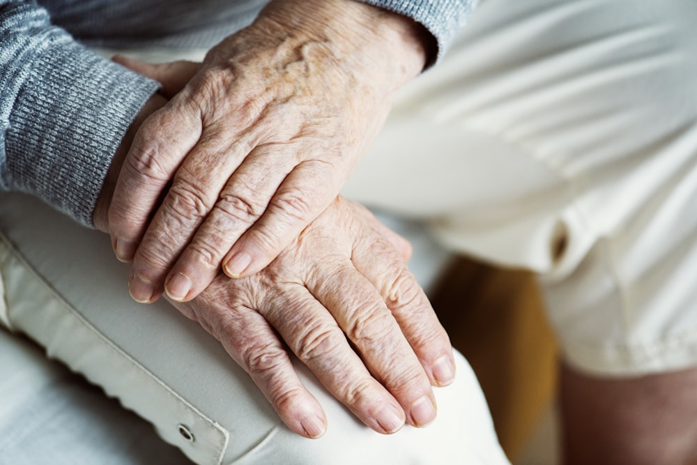 person's hands on lap