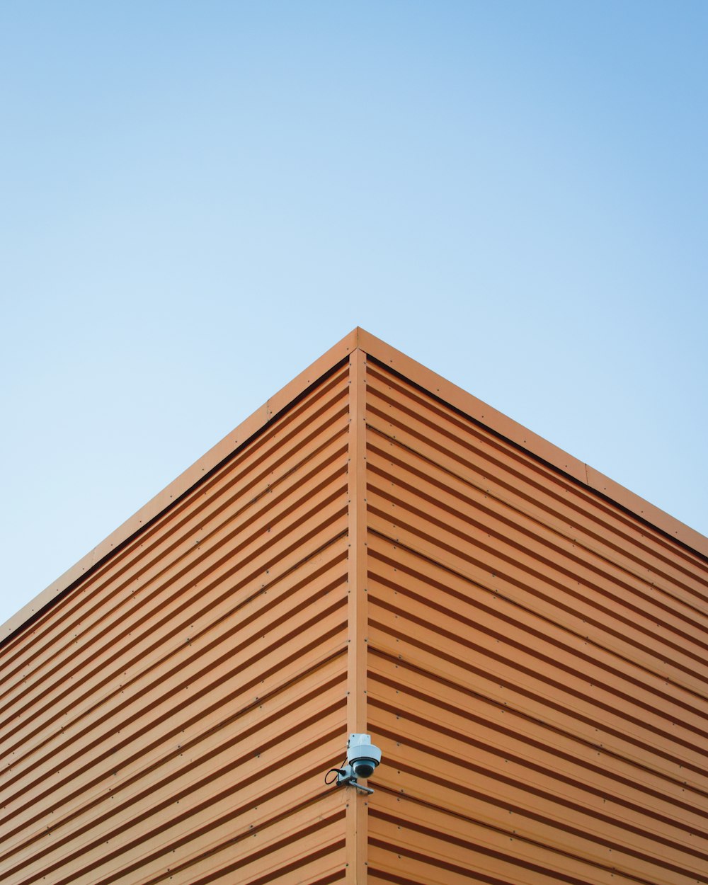 brown roof with surveillance camera attached