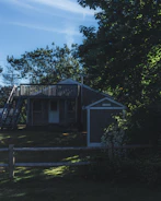 A freshly built small wooden house nestled in a quiet neighborhood.