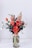 red flower arrangement on white table