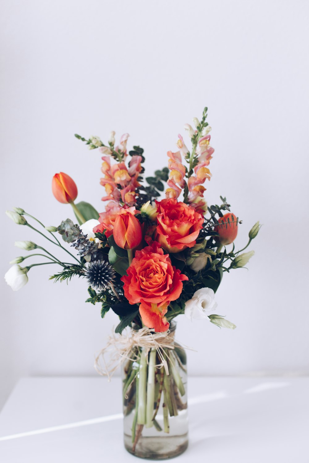 red flower arrangement on white table