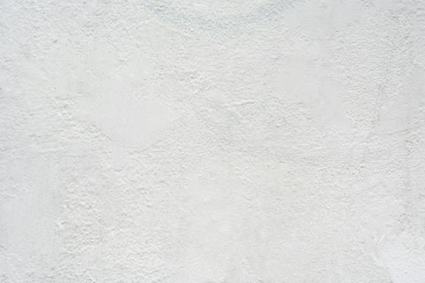 Close-up of a hand-troweled white plaster wall surface, the seamless texture Toronto homeowners get from microcement and Venetian plaster