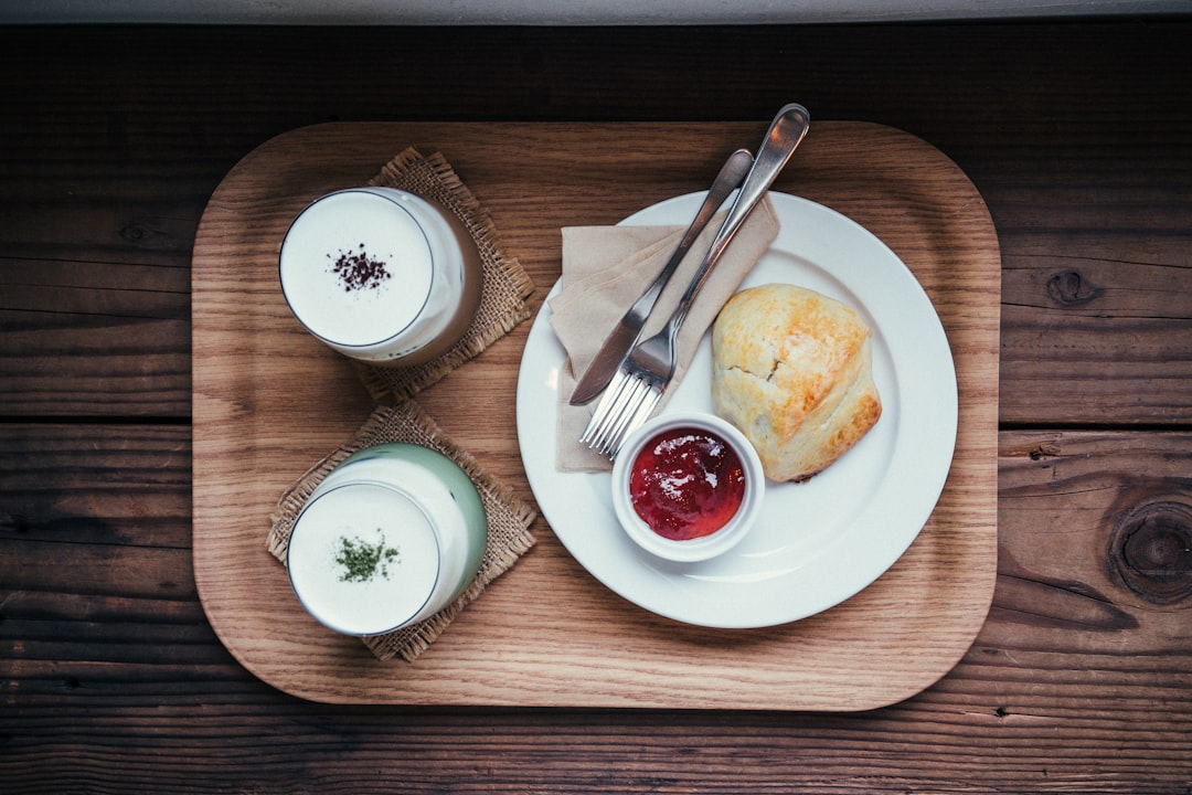 white bread on white plate beside fork and knife