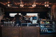 man facing coffeemaker at cafe