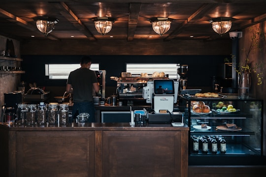 man facing coffeemaker at cafe
