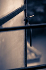 Close-up of a handyman fixing a window latch, ensuring it closes tightly against the frame.
