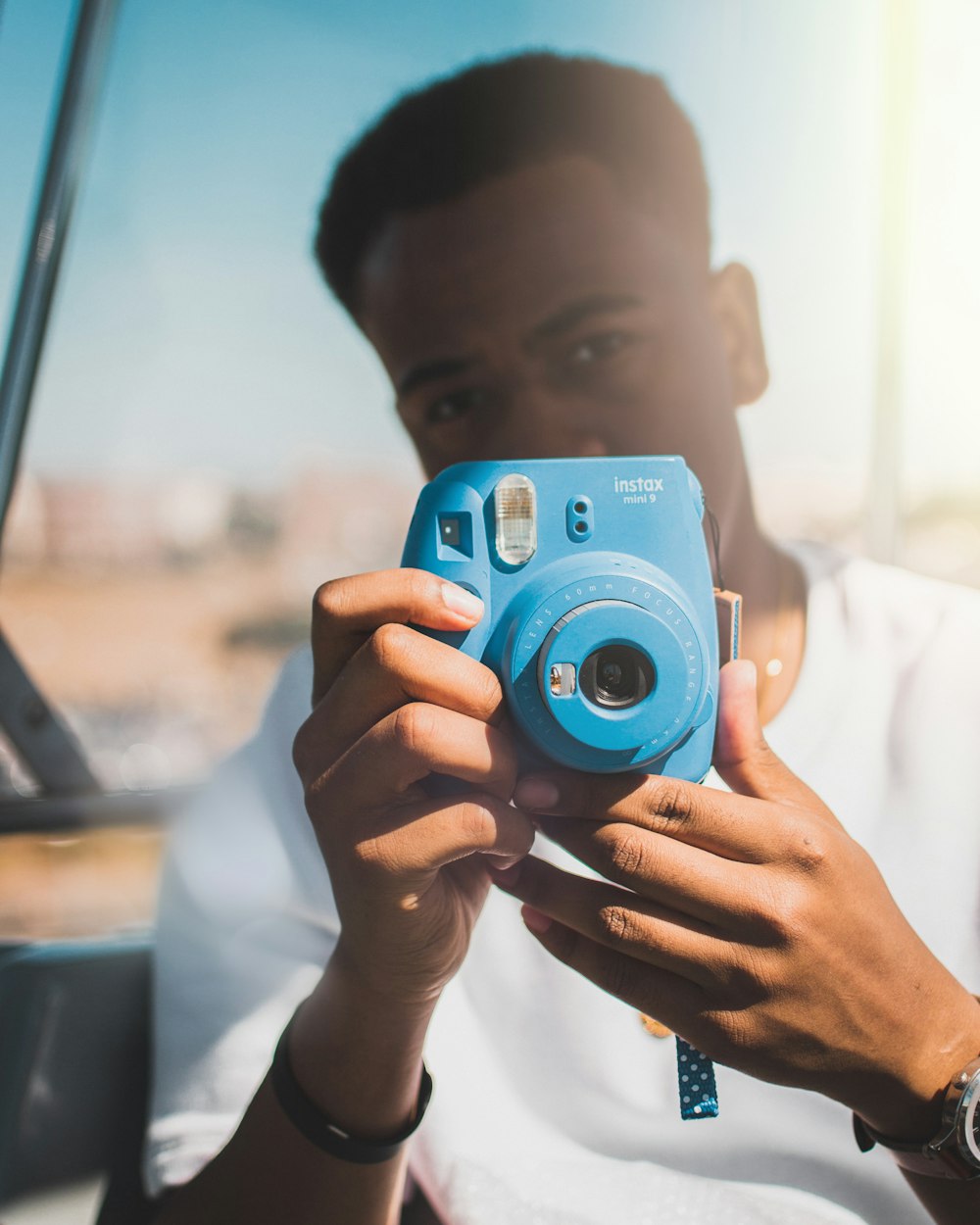 person using Fujifilm Instax Mini 9