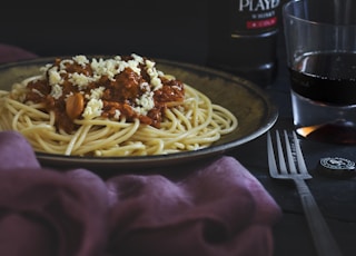 spaghetti beside fork and Andy bottle