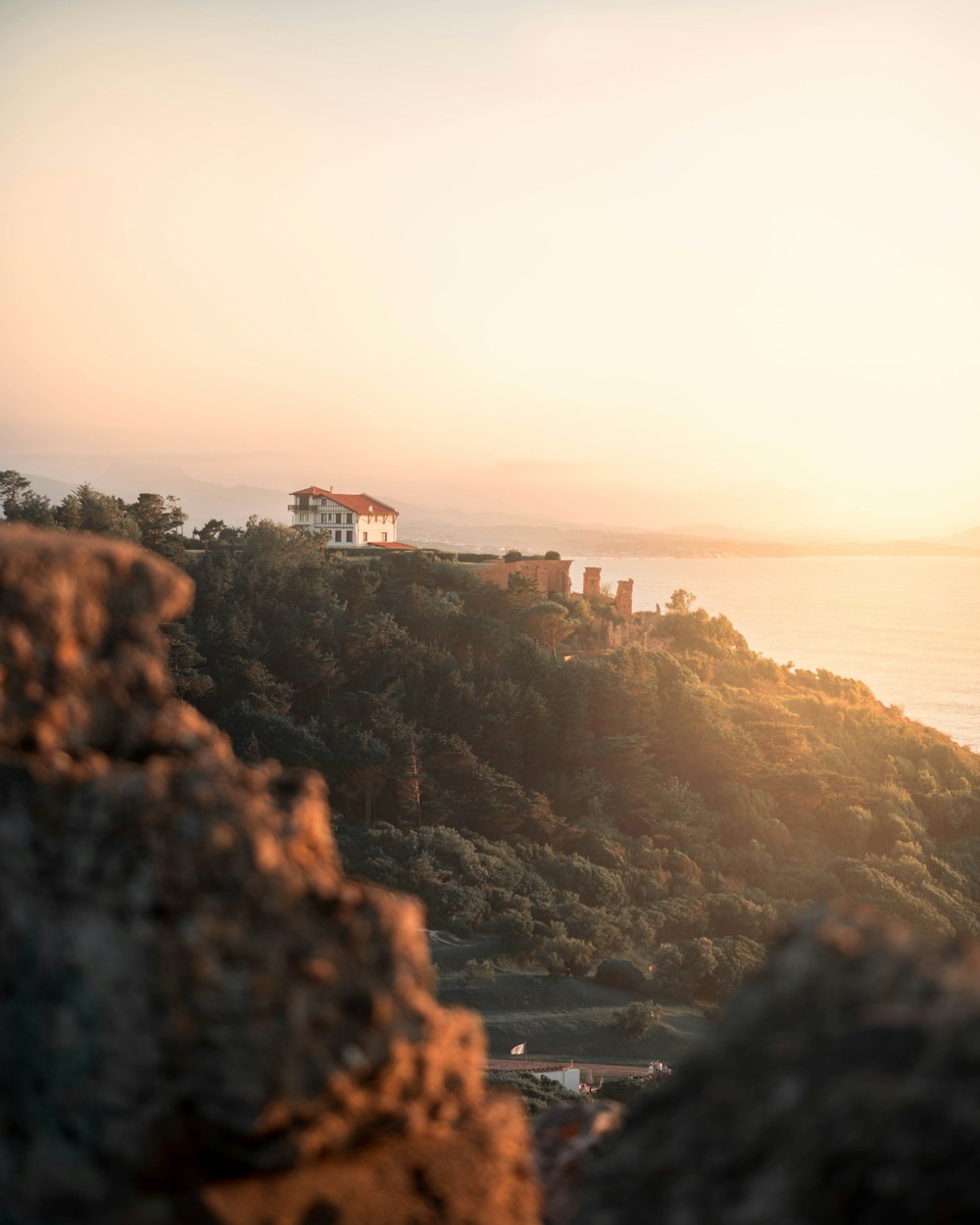 concrete castle on hill beside body of water