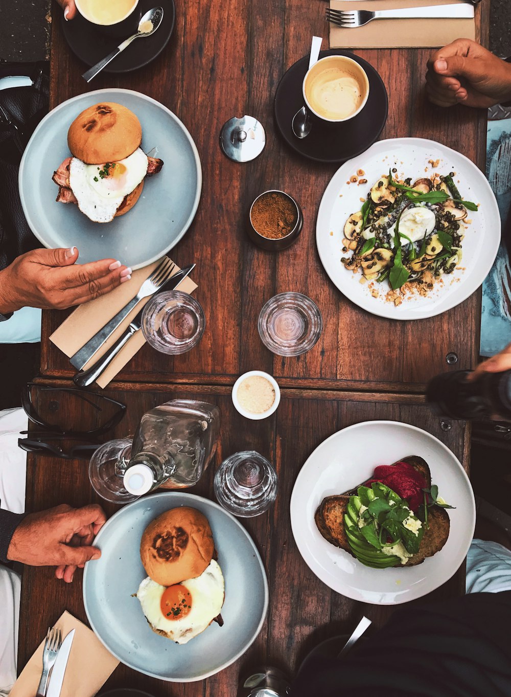 two round white and gray plates on table with egg sandwiches