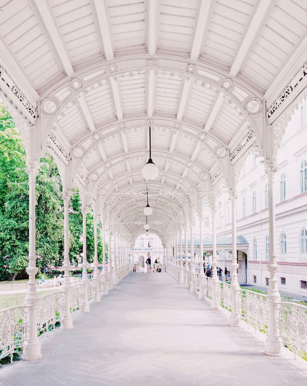 person walking on white hallway walkway