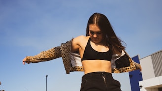 Photo of a model wearing a breathable sports jacket while stretching outdoors.