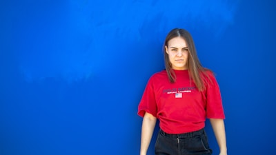 woman standing near blue wall