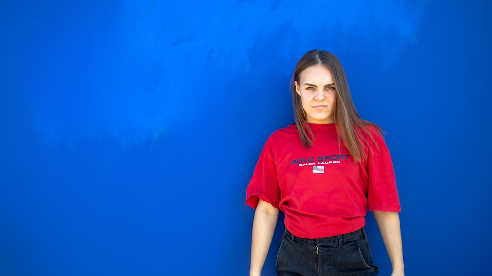 woman standing near blue wall