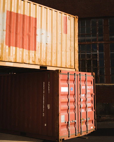 Modern office building with international shipping containers and customs clearance activity.