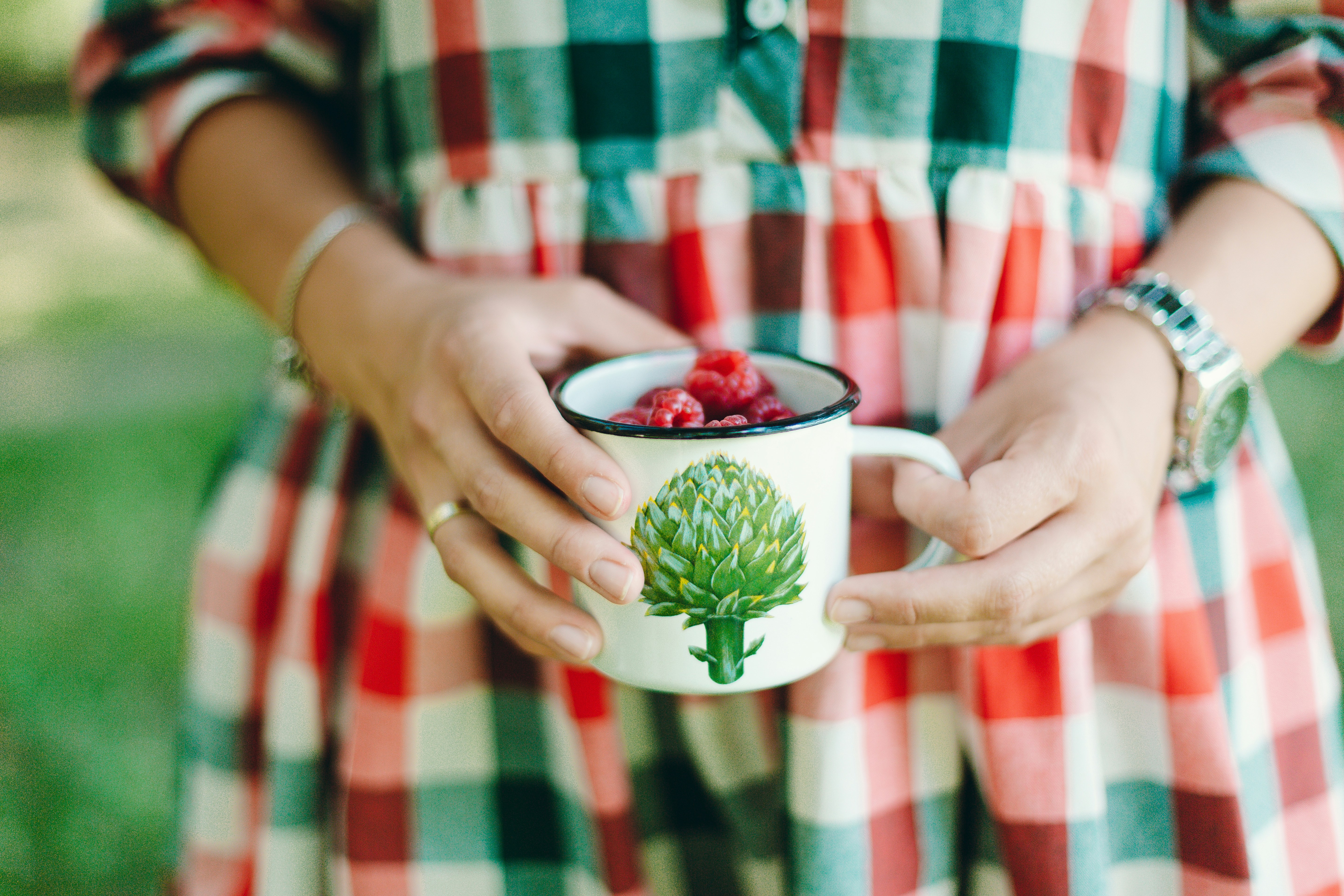 person holding cup of fruits