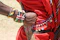 A close-up of a traveler’s hands holding traditional African beads during a cultural ceremony.