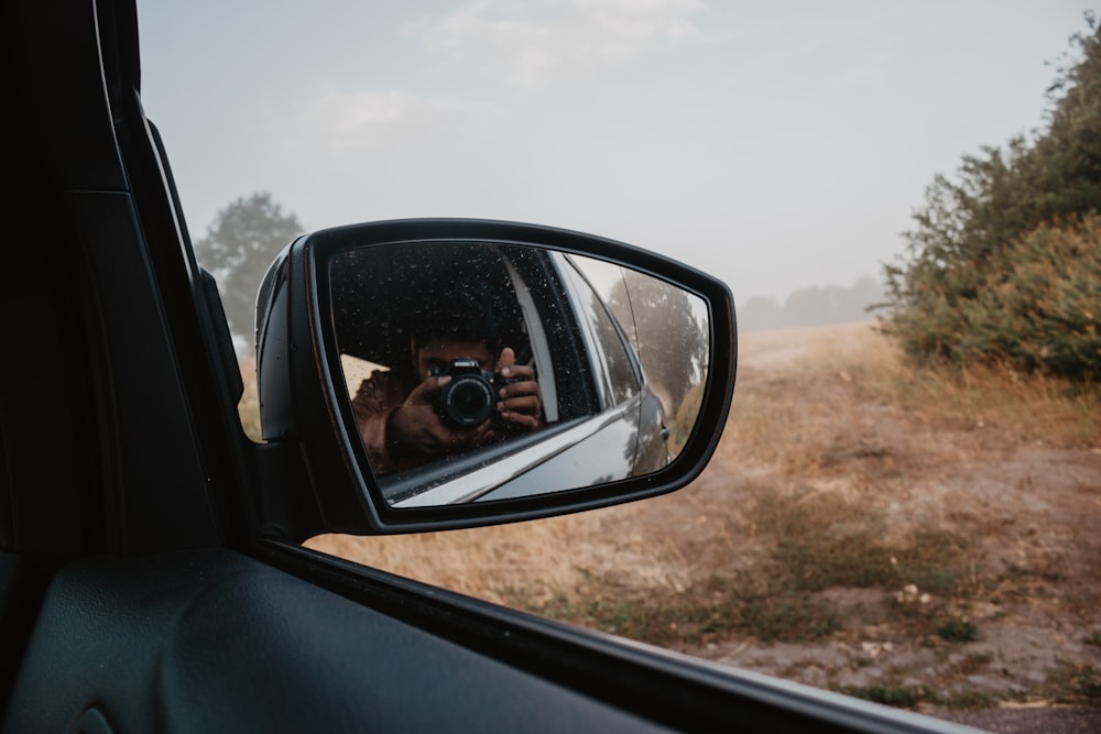 man holding camera taking pictures