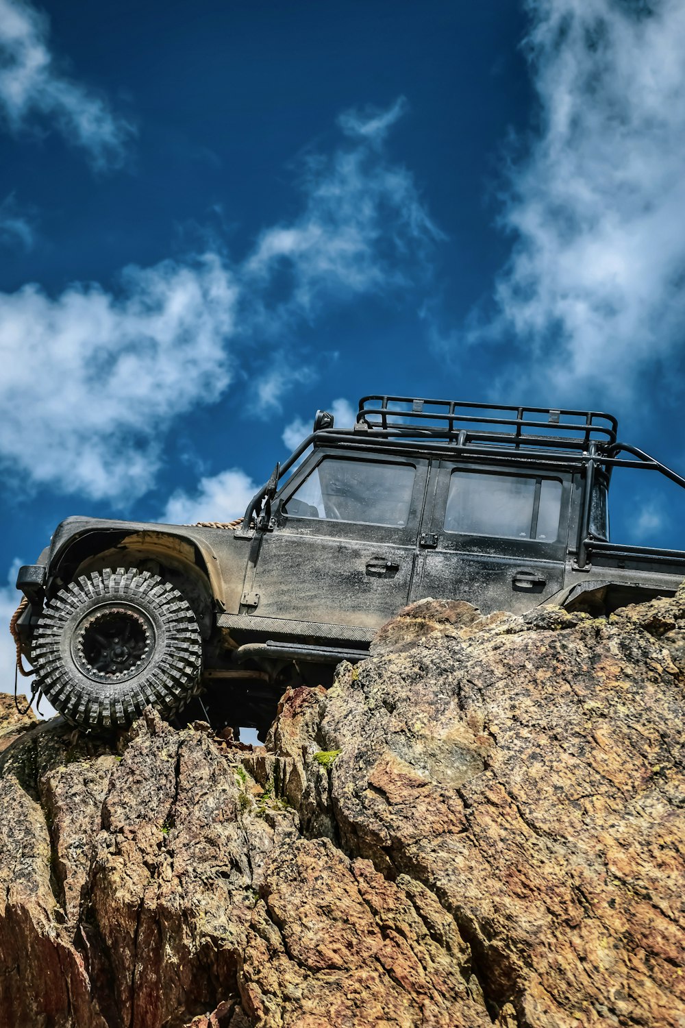 a jeep on top of a large rock