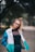 woman wearing jacket while standing and smiling