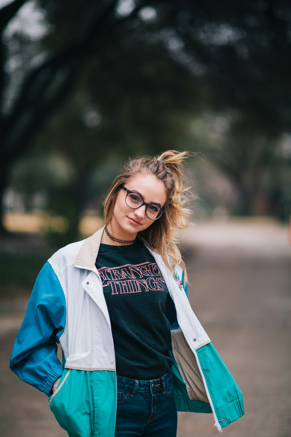 woman wearing jacket while standing and smiling