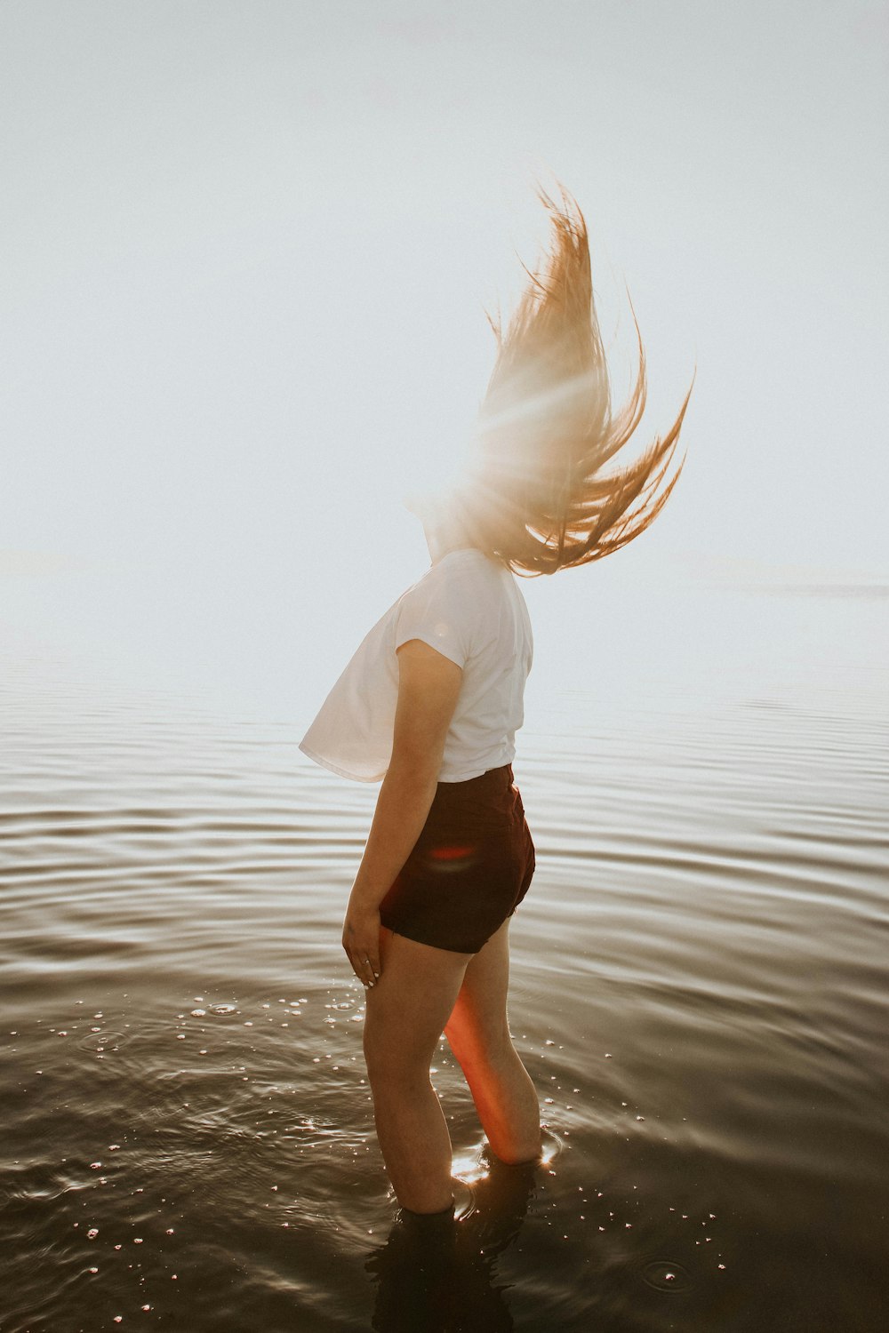 woman standing in body of water