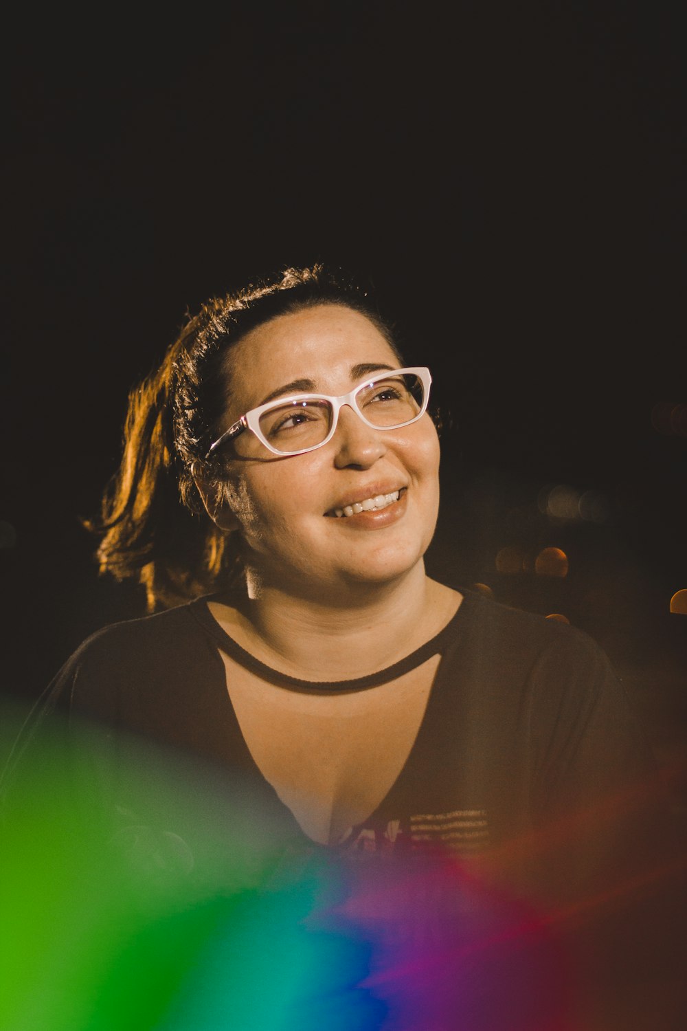 woman smiling while taking photo during nighttime