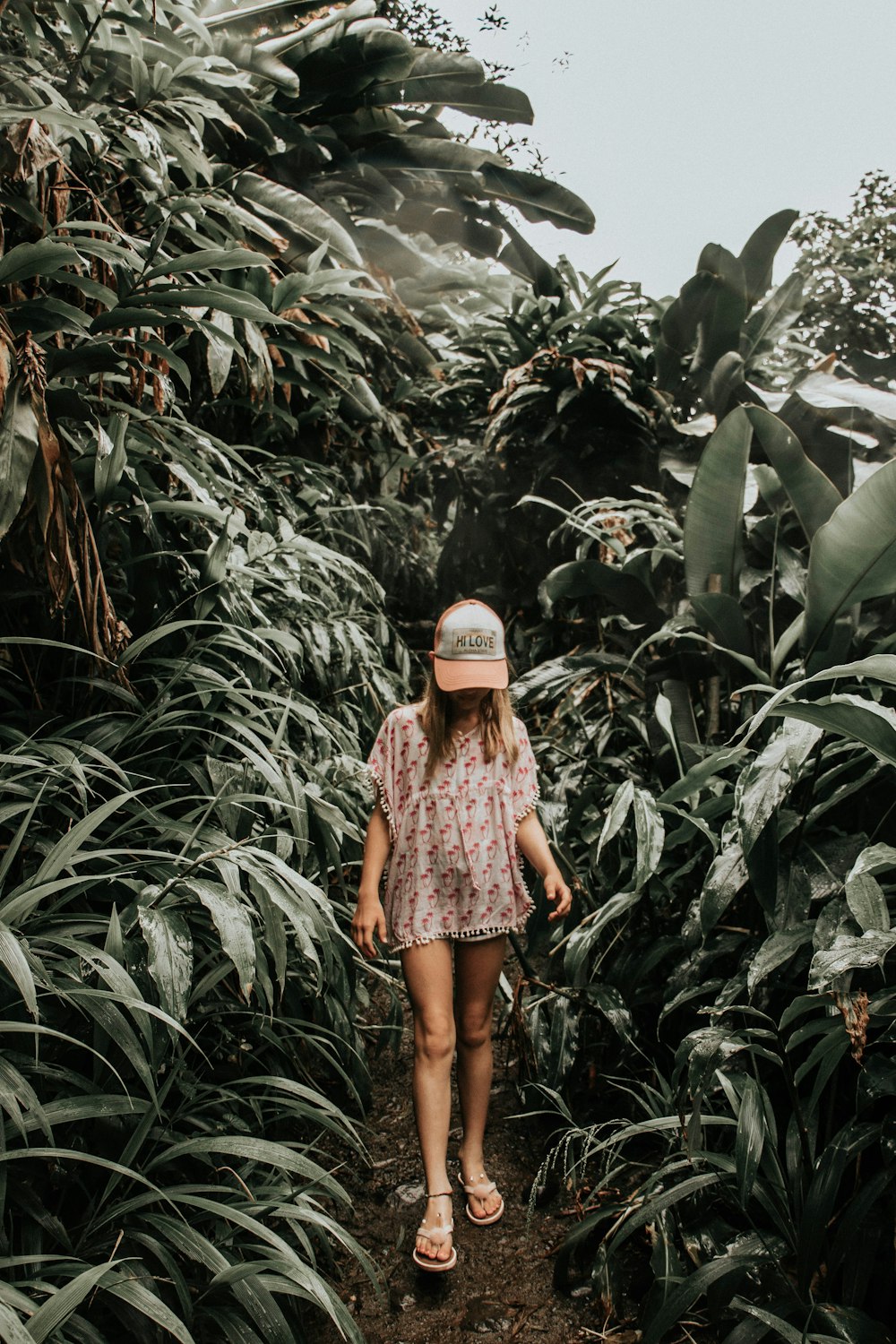 girl standing beside plants at daytime