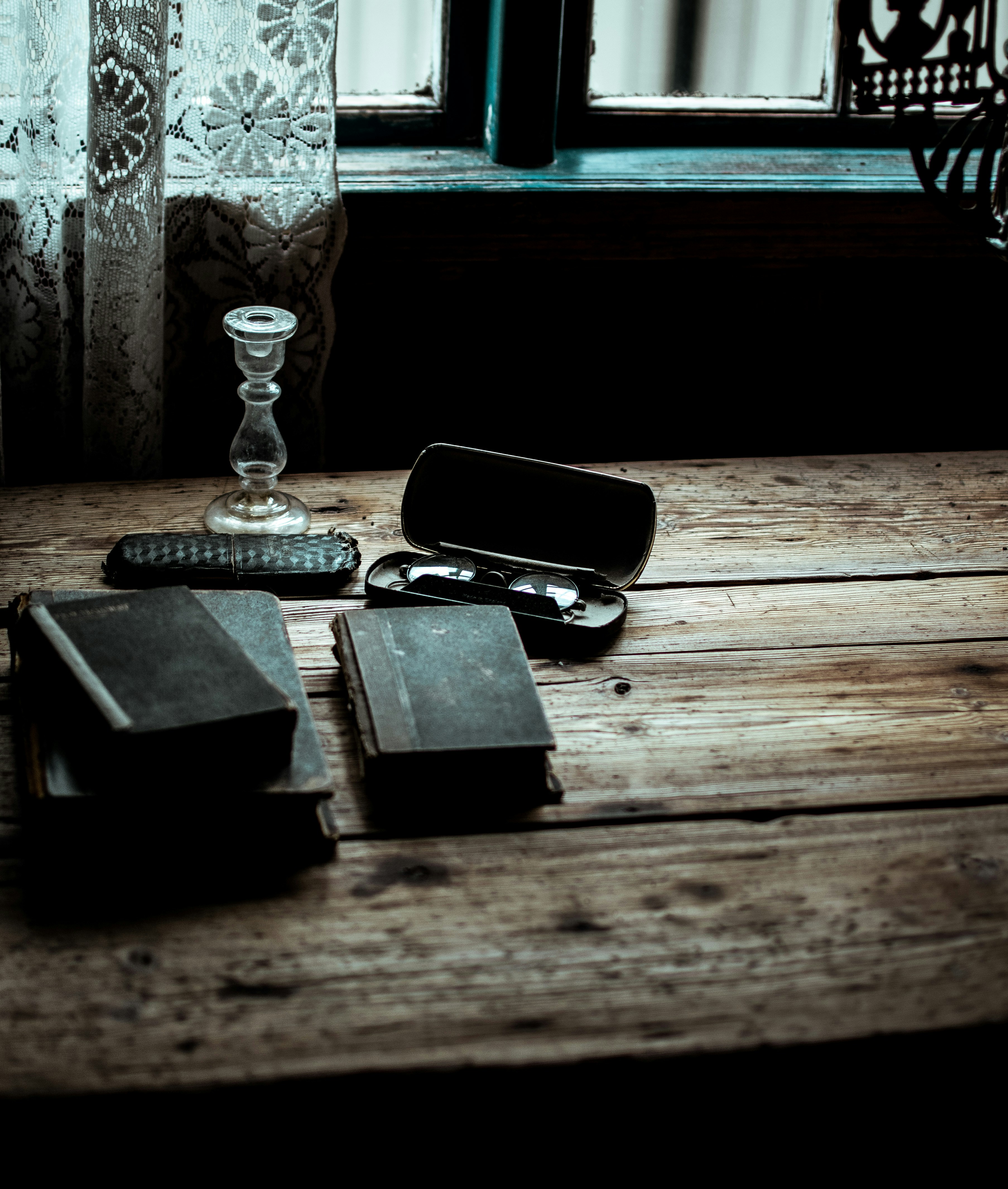 black covered book on wooden table