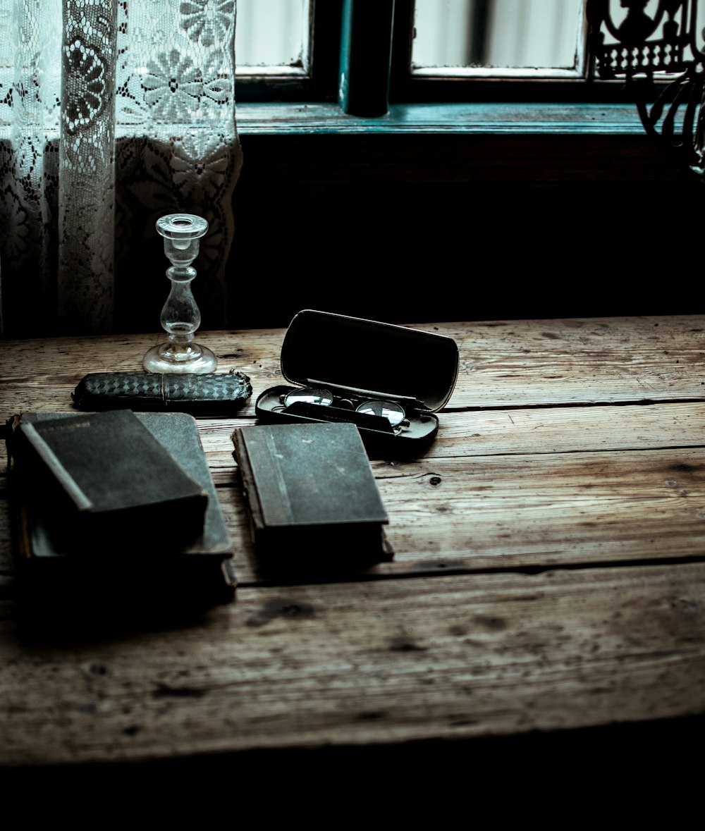 black covered book on wooden table