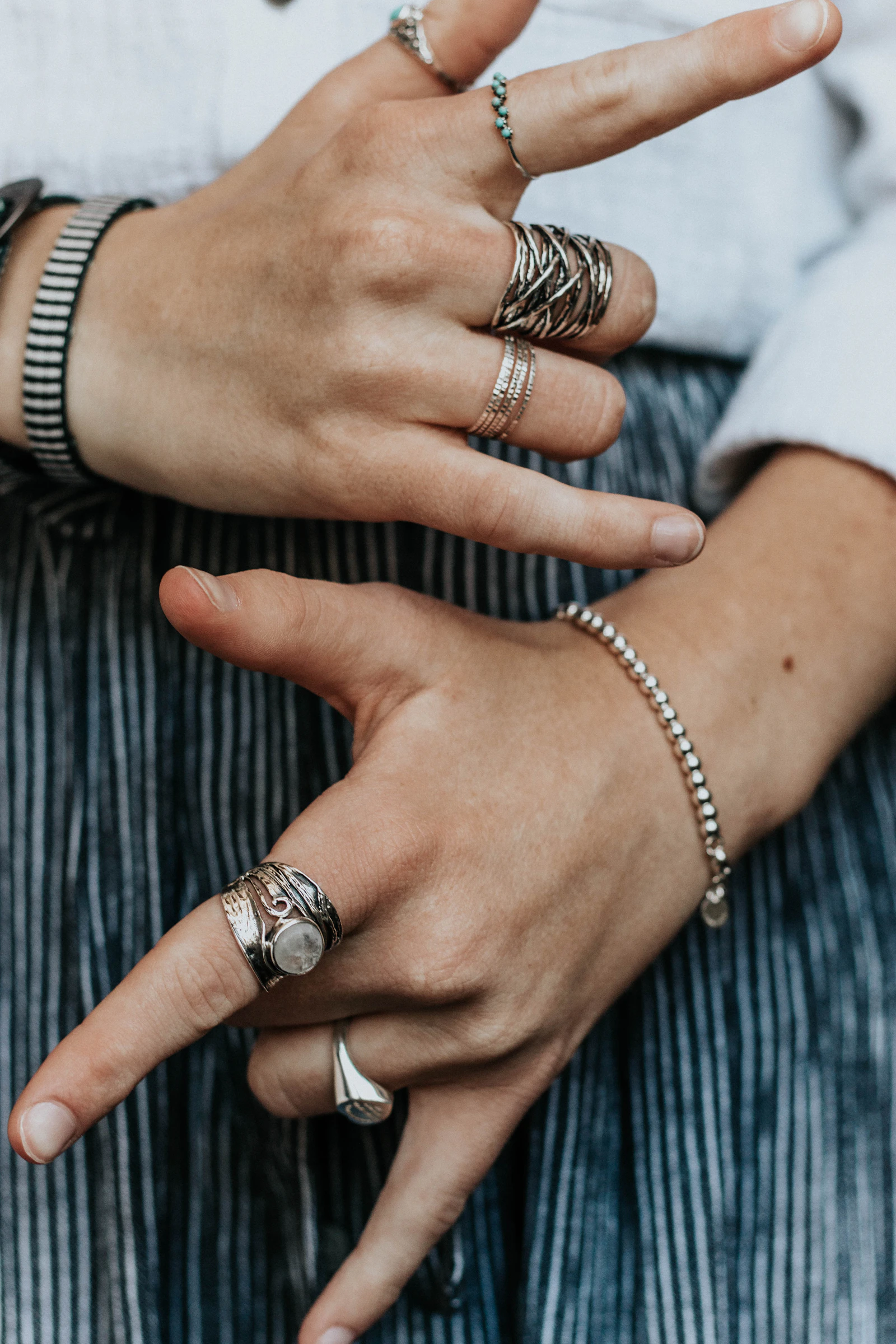 Hand wearing stacked silver and gold rings — the mixed-metal jewelry trend for fall 2026