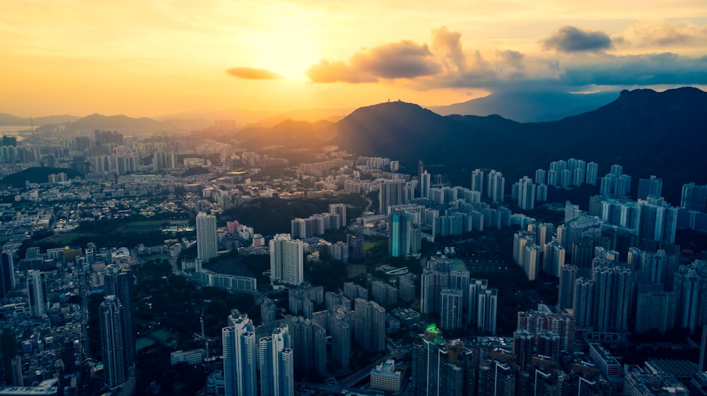 aerial photography of city scape near mountain during sunrise