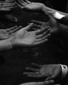 a group of people holding their hands together