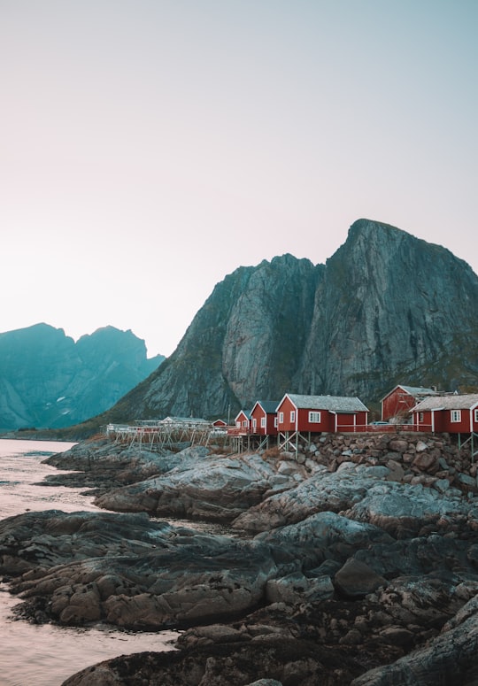 houses beside rock mountain in Reine Norway