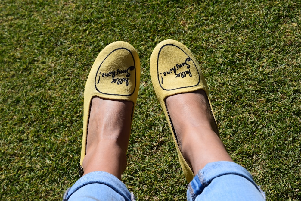 person wearing yellow slip-on shoes