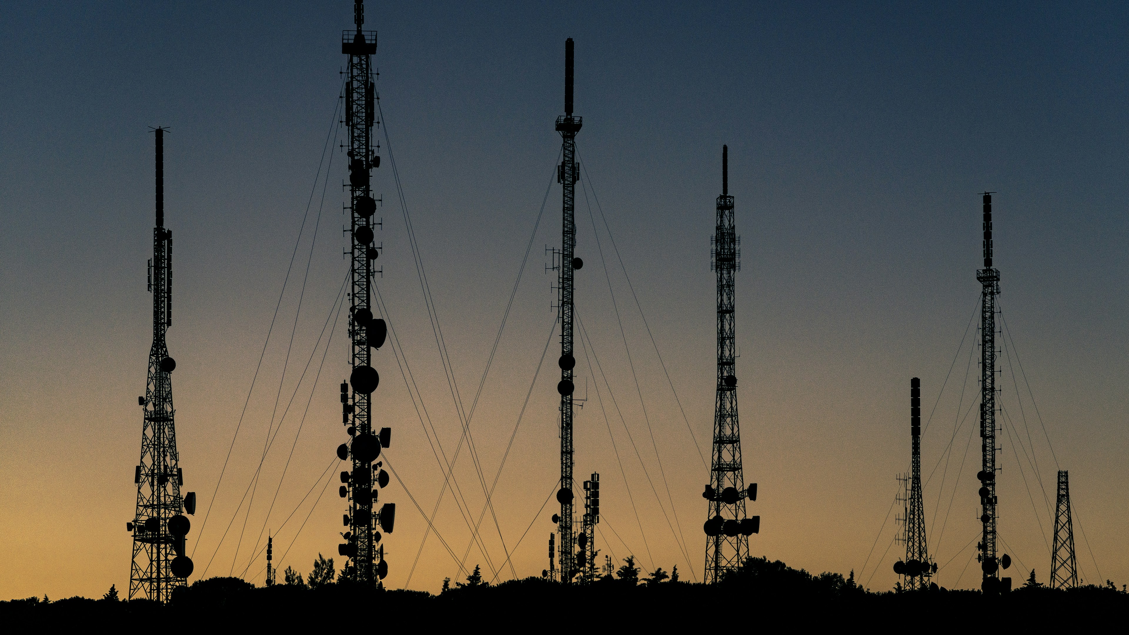 modern telecom cell tower against clear evening sky