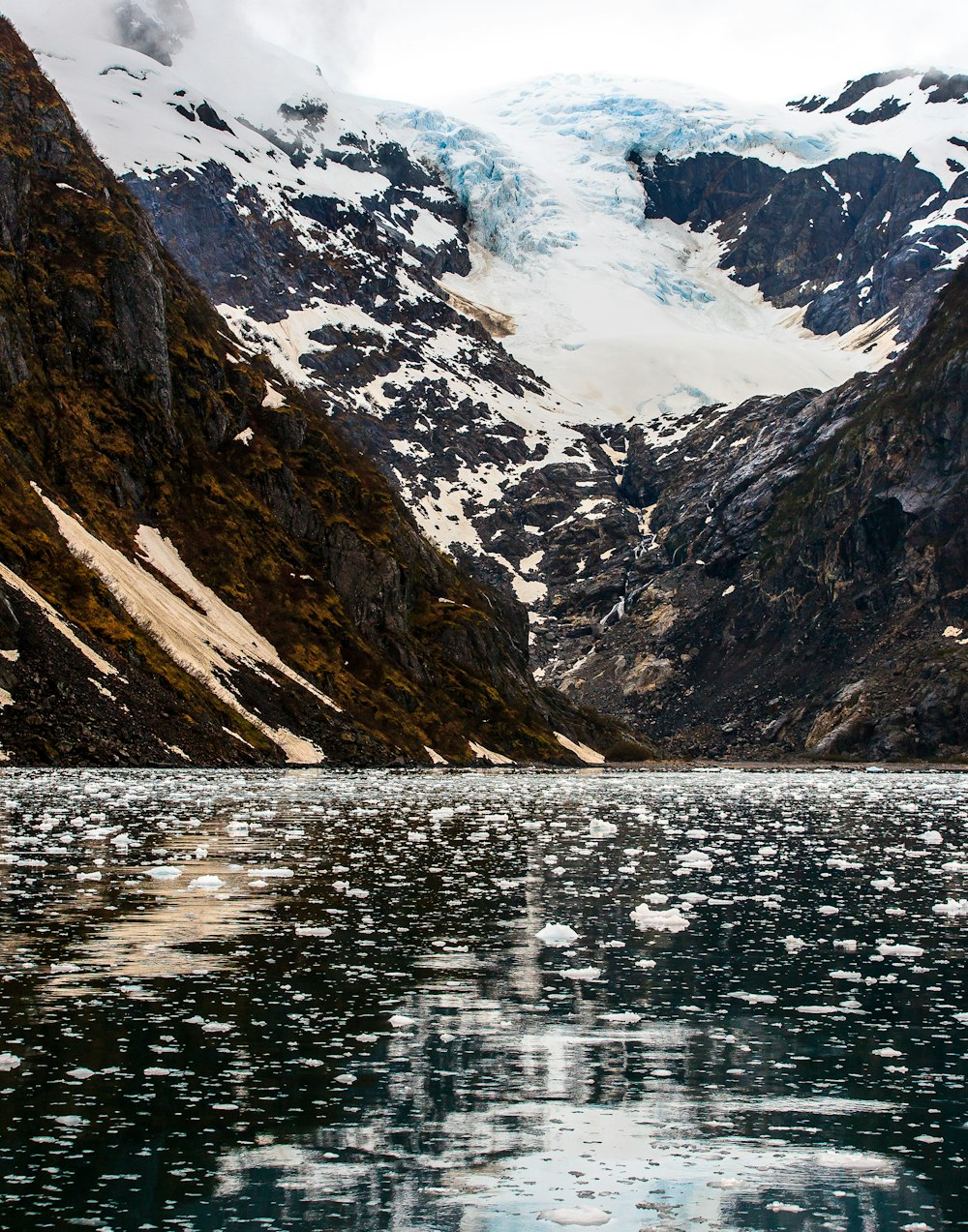 calm lake near glacier mountain at daytime