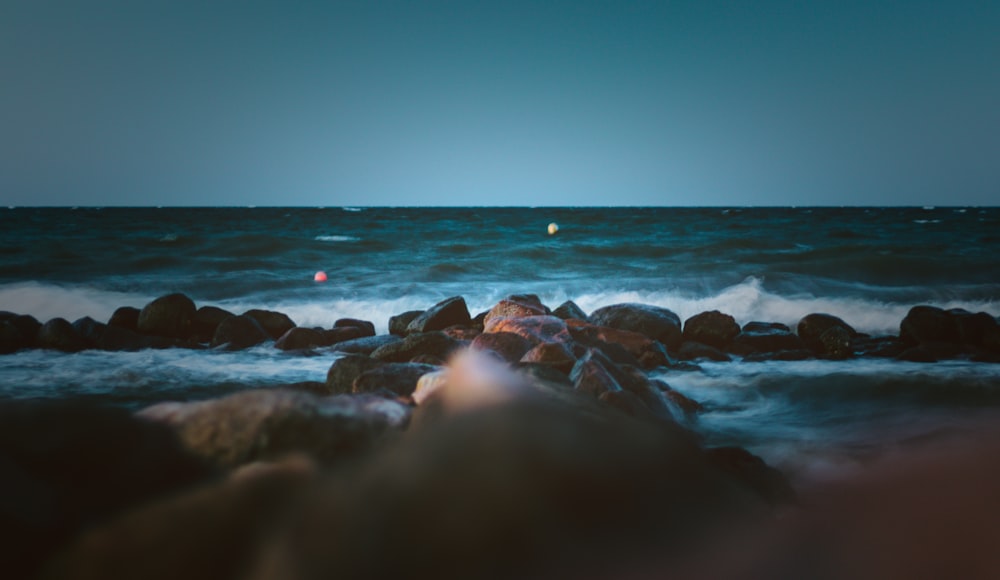 rocks beside body of water