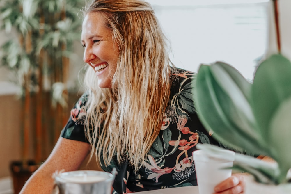 smiling woman sitting inside a room