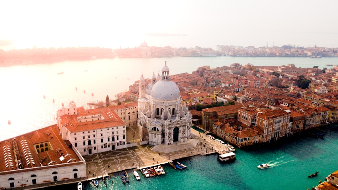 aerial photo of concrete buildings near calm water, A beautiful sunset in the city of love : Venice<p></figure>@canmandawe