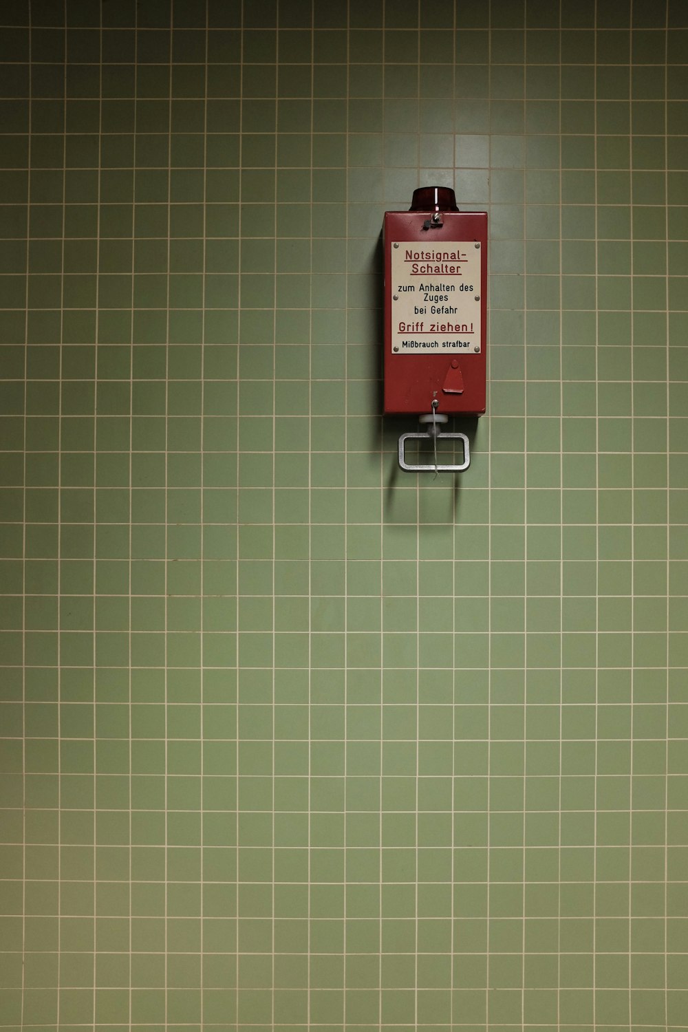 red and white National Schalter wall component on green wall