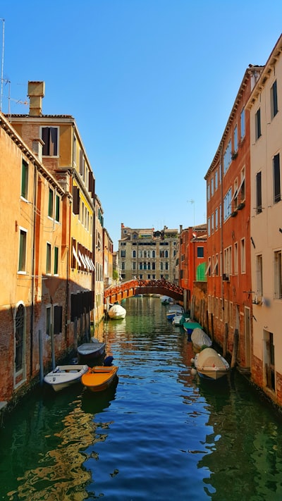 boats ported beside buildings during daytime