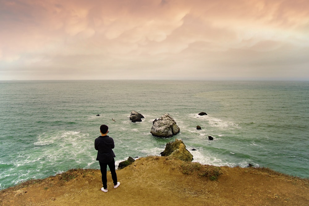 person standing on seashore